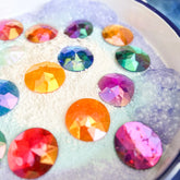 Close-up of colorful gemstones on a textured surface