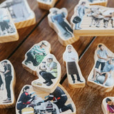 Wooden blocks with printed images of people on a wooden surface