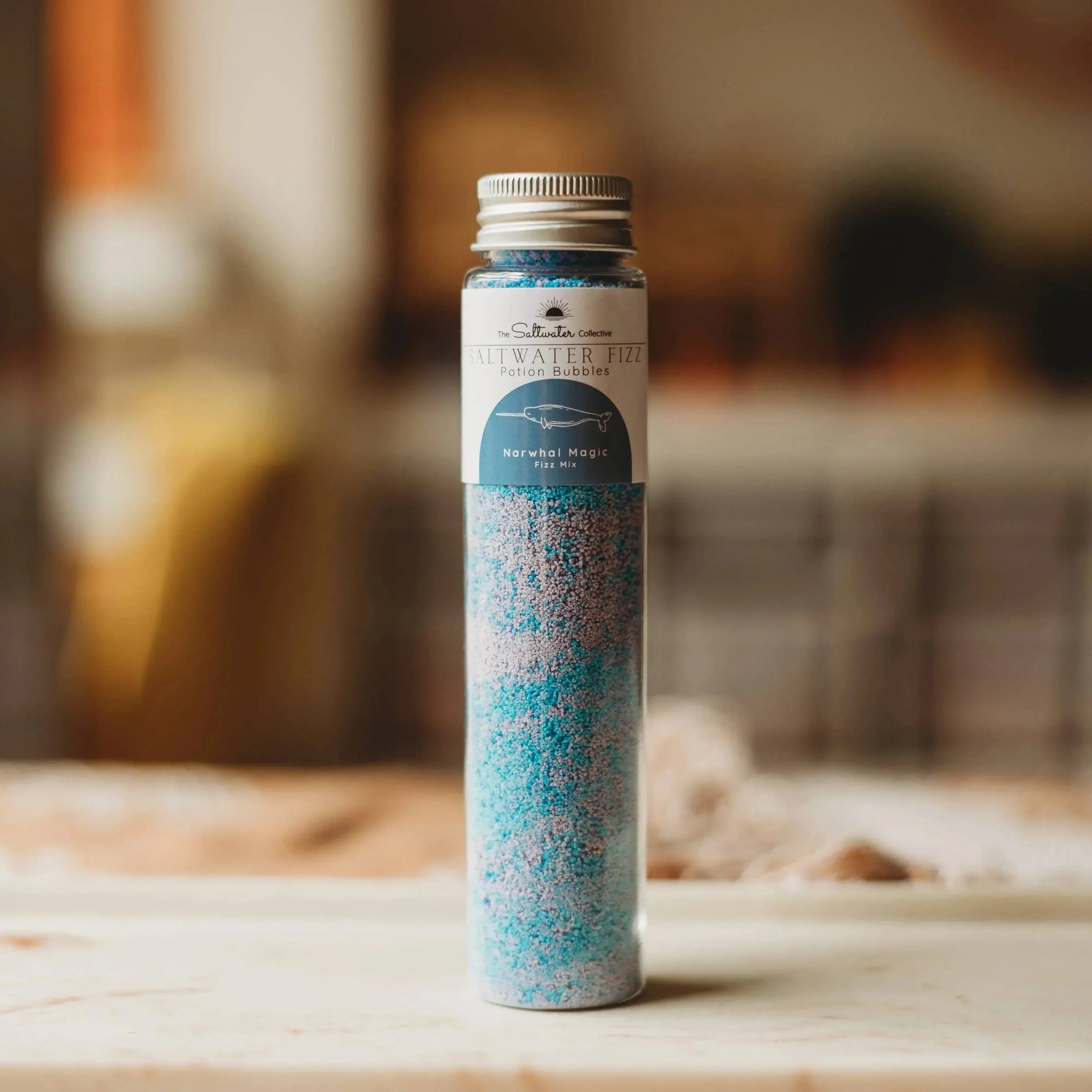 Tub of potion play salts with a decorative label on a wooden surface