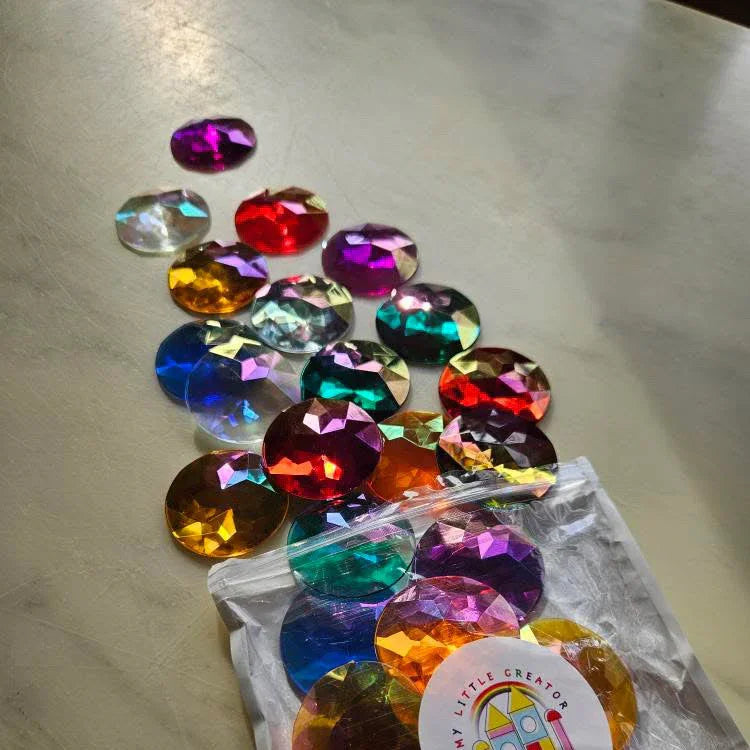 Colorful gemstones in a clear plastic bag on a marble surface with a brand label.