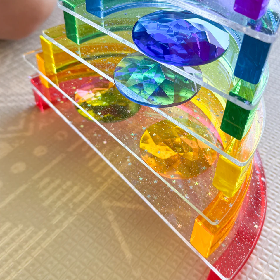 Colourful acrylic rainbow on glitter platform structure 
